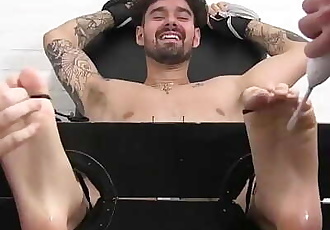 Tattoo jock Casey has feet torment in softcore bondage